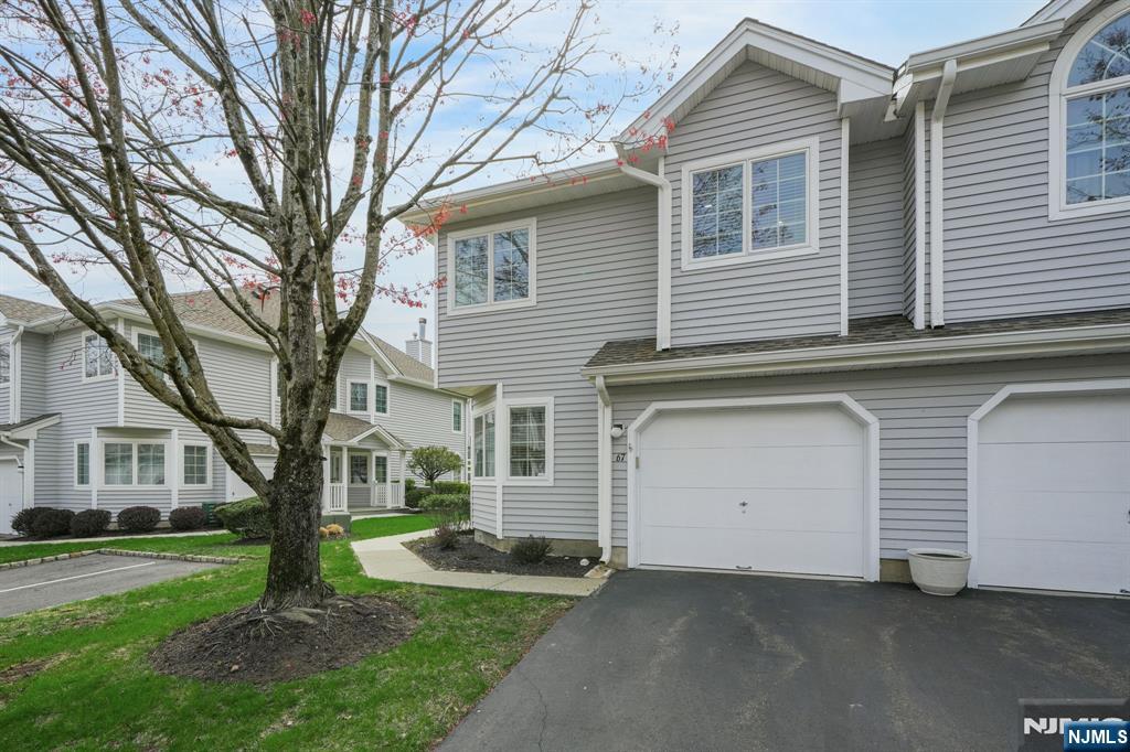 67 Davenport Road Montville, NJ 07045 - Photo 27 of 32 a front view of a house with a garden and trees