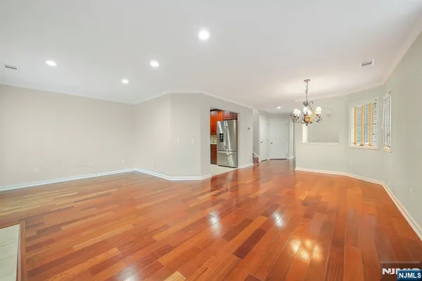 a view of livingroom with hardwood floor and kitchen view