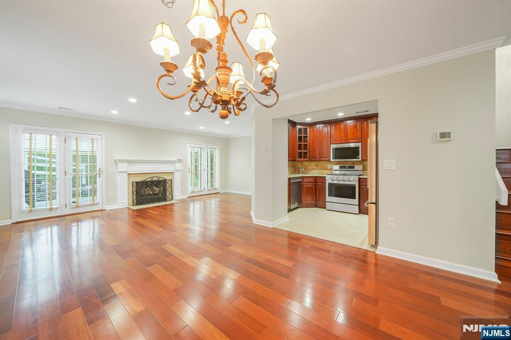 67 Davenport Road Montville, NJ 07045 - Photo 6 of 32 an empty room with wooden floor fireplace and windows