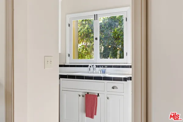 a kitchen with a sink stove and cabinets