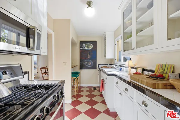 a kitchen with a sink appliances and cabinets