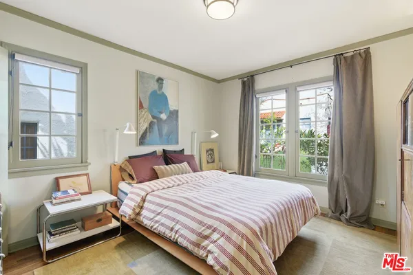 a bedroom with a bed and a mirror