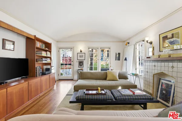 a kitchen with stainless steel appliances granite countertop a refrigerator and a wooden floor