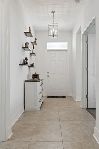 a view of kitchen with cabinets and window