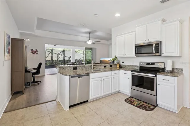a kitchen with stainless steel appliances a stove sink microwave and cabinets