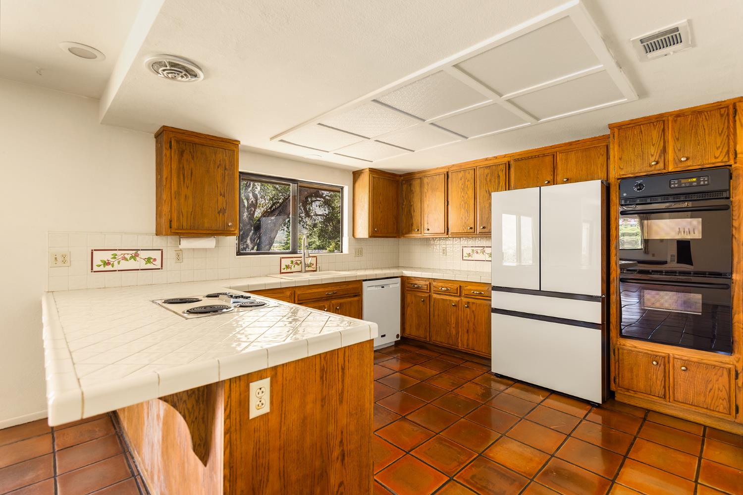 534 Fairview Road Ojai, CA 93023 - Photo 14 of 20 a kitchen with stainless steel appliances a refrigerator sink and cabinets