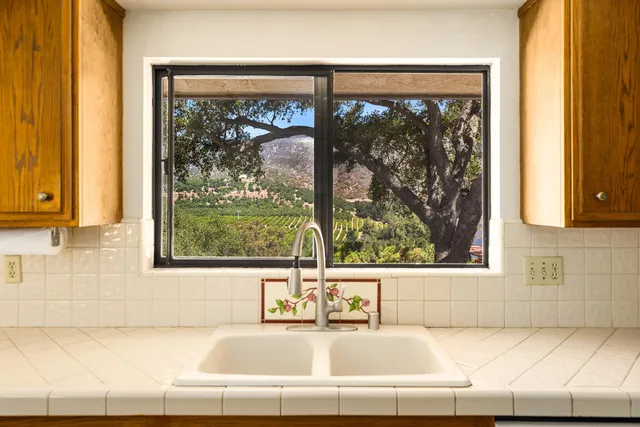 a white bath tub sitting in front of a window