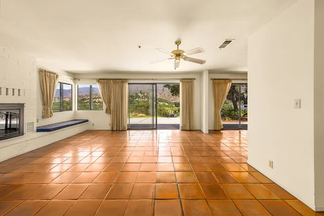 a view of an empty room with a fireplace
