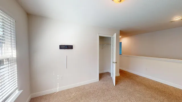 an empty room with a empty space and windows