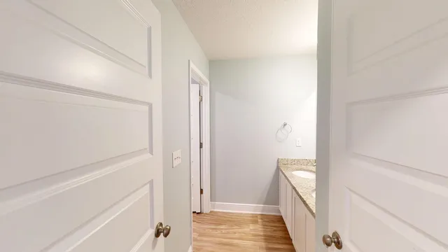 a view of an empty room with wooden floor