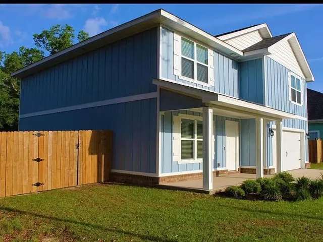 a backyard of a house with lots of green space