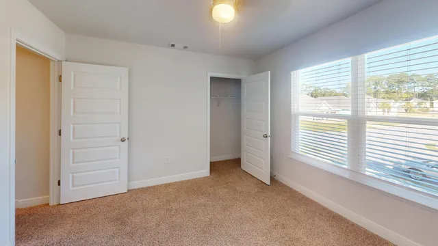 a view of a livingroom with a hardwood floor and a ceiling fan