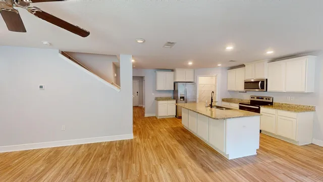 a kitchen with a refrigerator and a sink