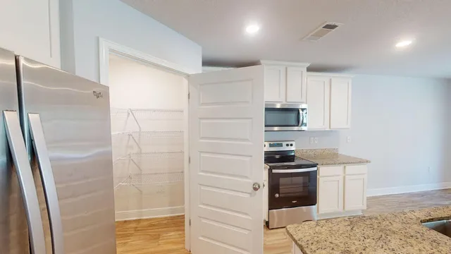 a kitchen with a stove a sink and a refrigerator