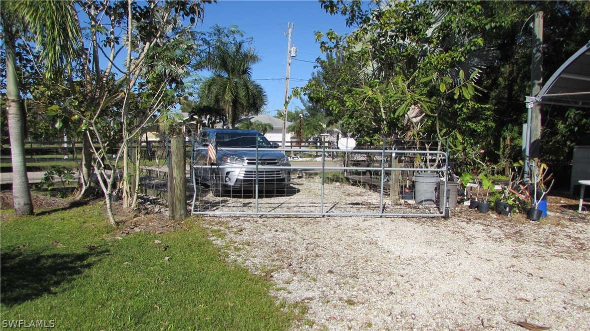 8390 Stringfellow Road St. James City, FL 33956 - Photo 3 of 35 a view of a yard with wooden fence