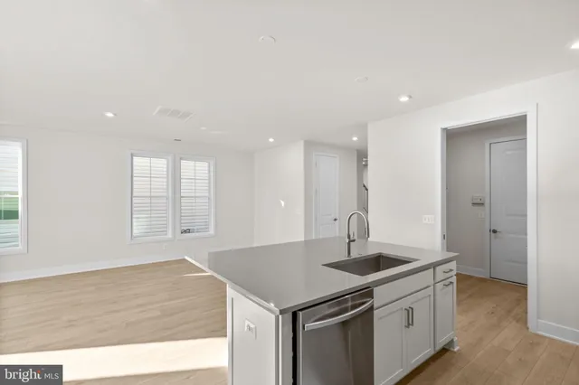 a kitchen with stainless steel appliances granite countertop a sink a stove and a refrigerator