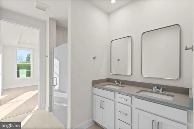 a bathroom with double sink and a mirror