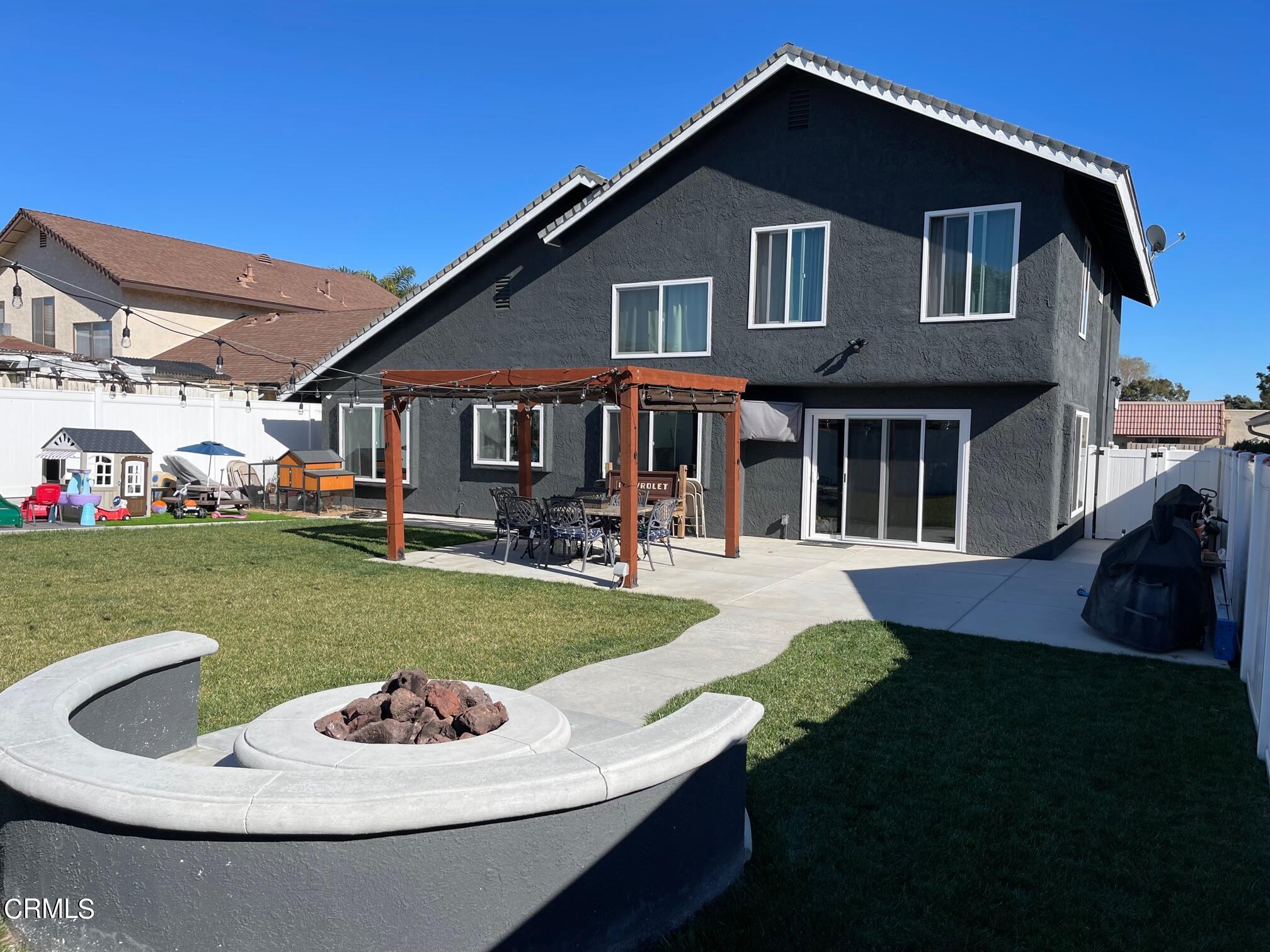 1831 Jetty Street Oxnard, CA 93035 - Photo 16 of 20 a front view of a house with a yard fire pit and outdoor seating