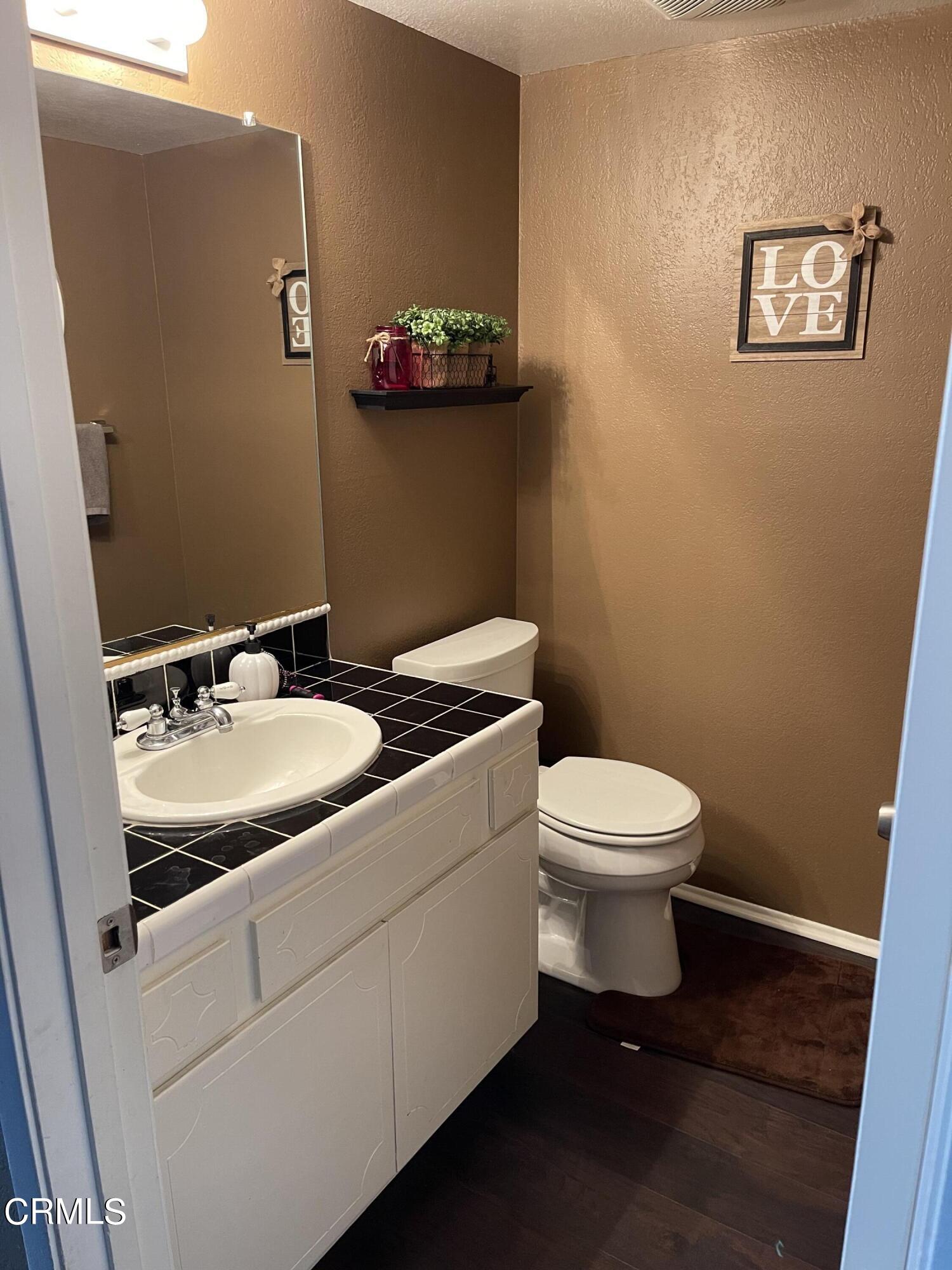 1831 Jetty Street Oxnard, CA 93035 - Photo 7 of 20 a bathroom with a sink toilet and a mirror