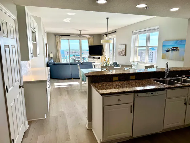 a large kitchen with kitchen island a sink stainless steel appliances and cabinets