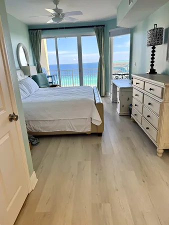 a bedroom with a bed next to a large window with the outer view