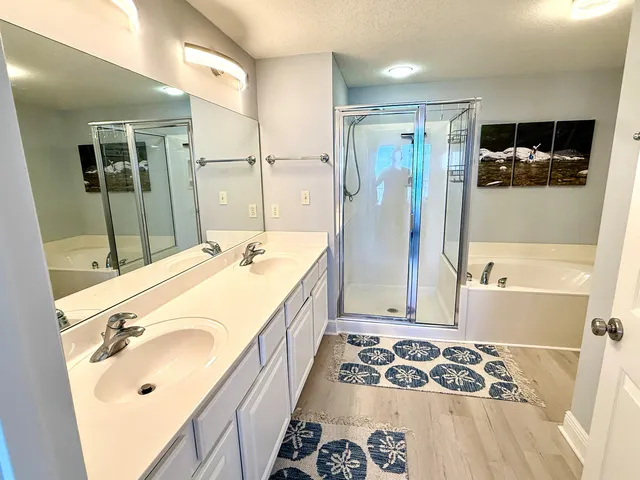 a bathroom with a tub sink and mirror