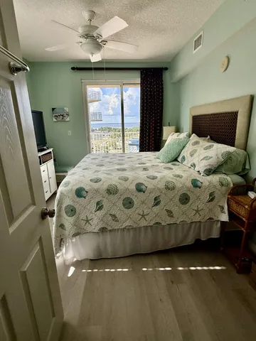a bedroom with a bed and a large window