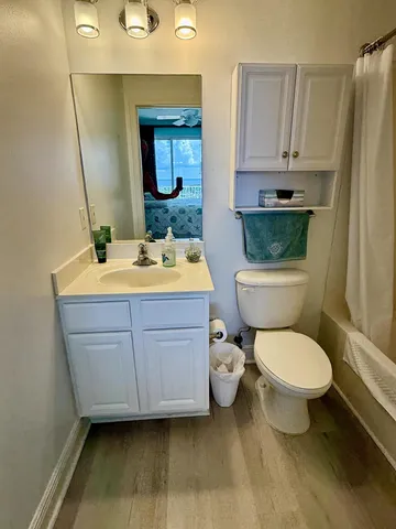 a bathroom with a toilet sink and mirror