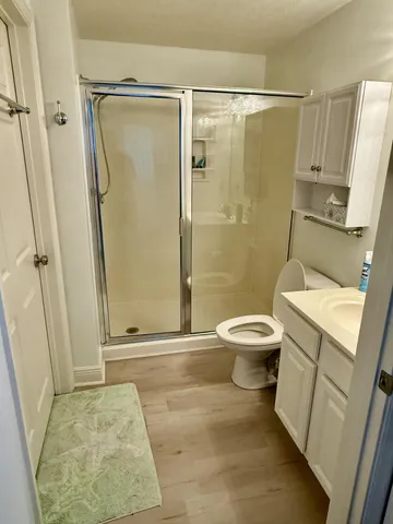 a bathroom with a toilet and a shower