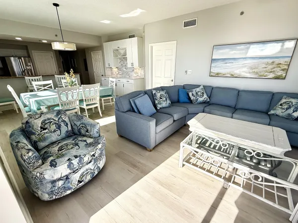 a living room with furniture and a chandelier