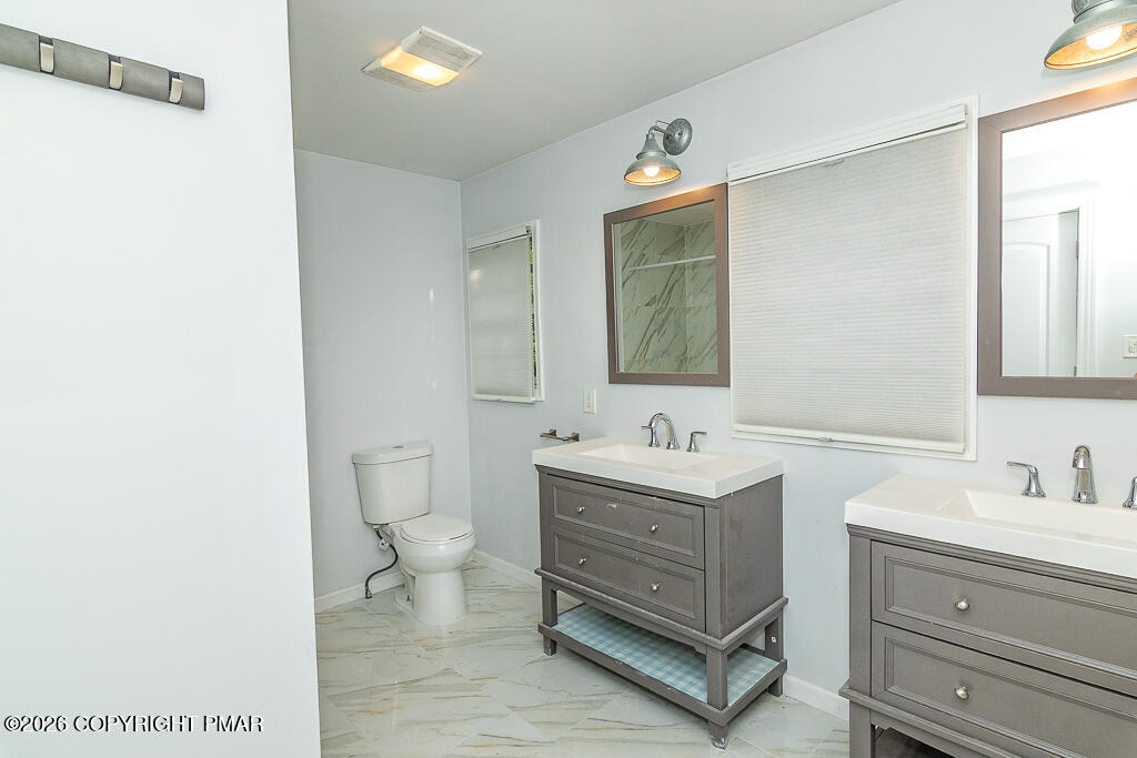 755 White Oak Road Cresco, PA 18326 - Photo 22 of 50 a bathroom with a toilet sink and mirror