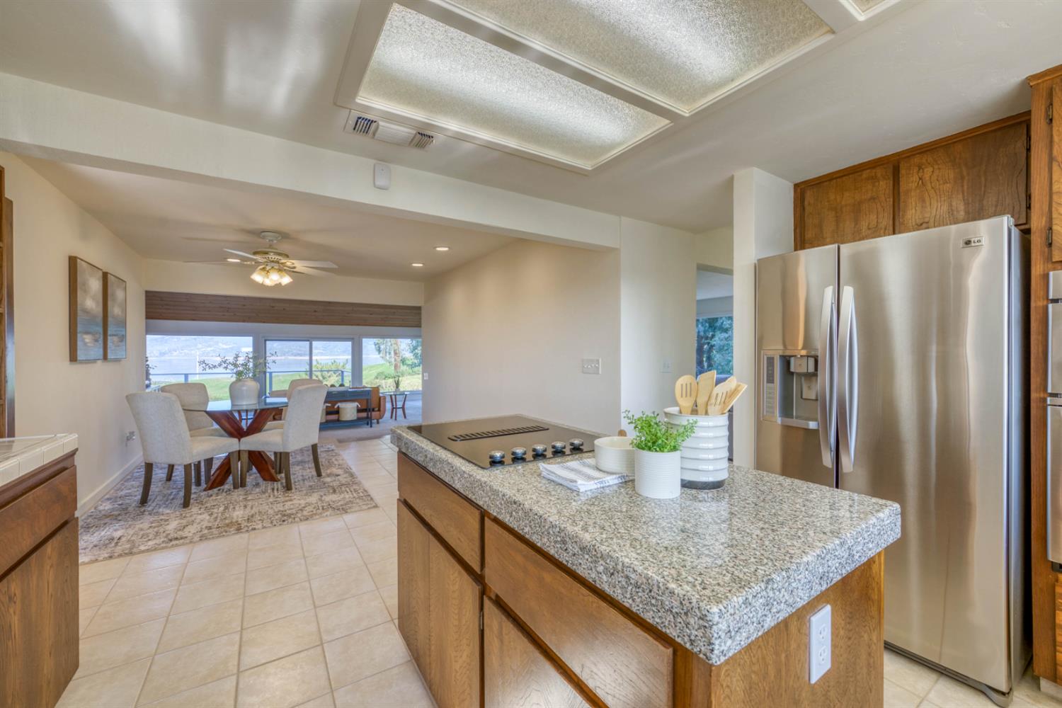 4578 Millerton Road Friant, CA 93626 - Photo 18 of 97 a kitchen with stainless steel appliances granite countertop a sink dishwasher and a refrigerator