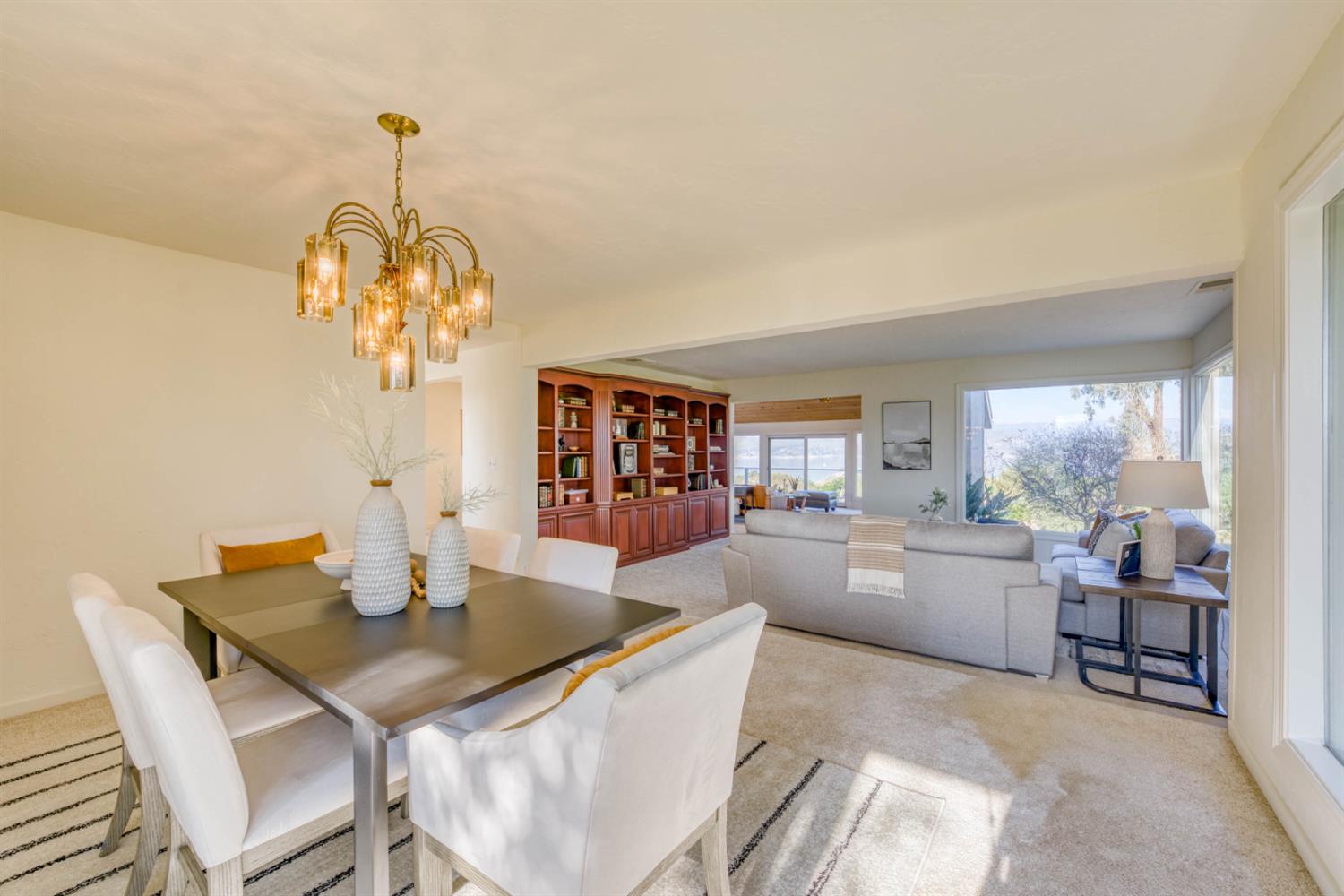 4578 Millerton Road Friant, CA 93626 - Photo 26 of 97 a dining room with furniture a chandelier and wooden floor