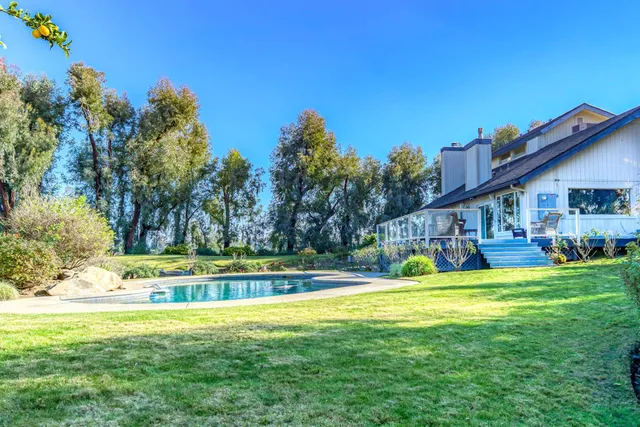a view of a swimming pool with a yard