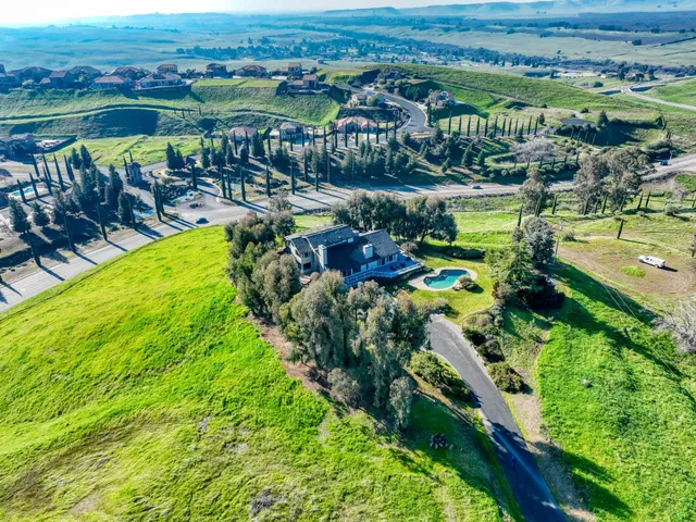 a view of a swimming pool with a deck and furniture