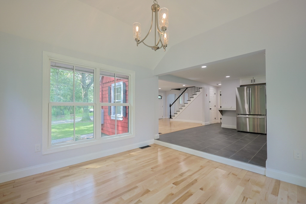 25 Bailey Road Townsend, MA 01474 - Photo 3 of 29 a view of a hallway with wooden floor and a living room