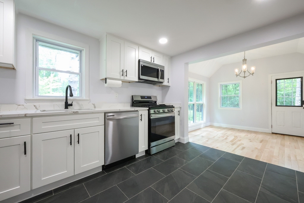 25 Bailey Road Townsend, MA 01474 - Photo 6 of 29 a kitchen with a stove a sink and a microwave
