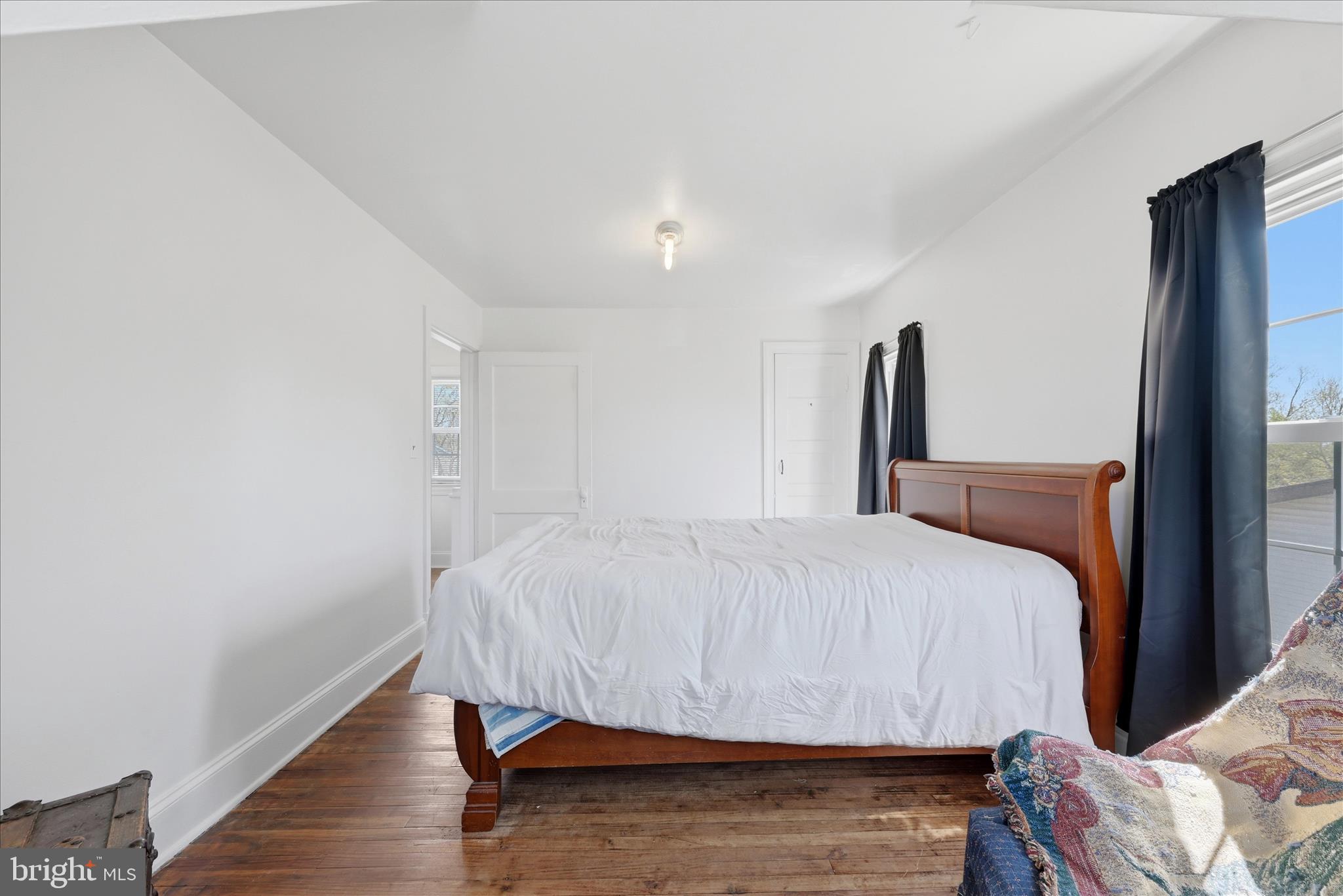 510 North Pleasant Valley Road Winchester, VA 22601 - Photo 39 of 63 a bed sitting in a bedroom next to a window with wooden floor
