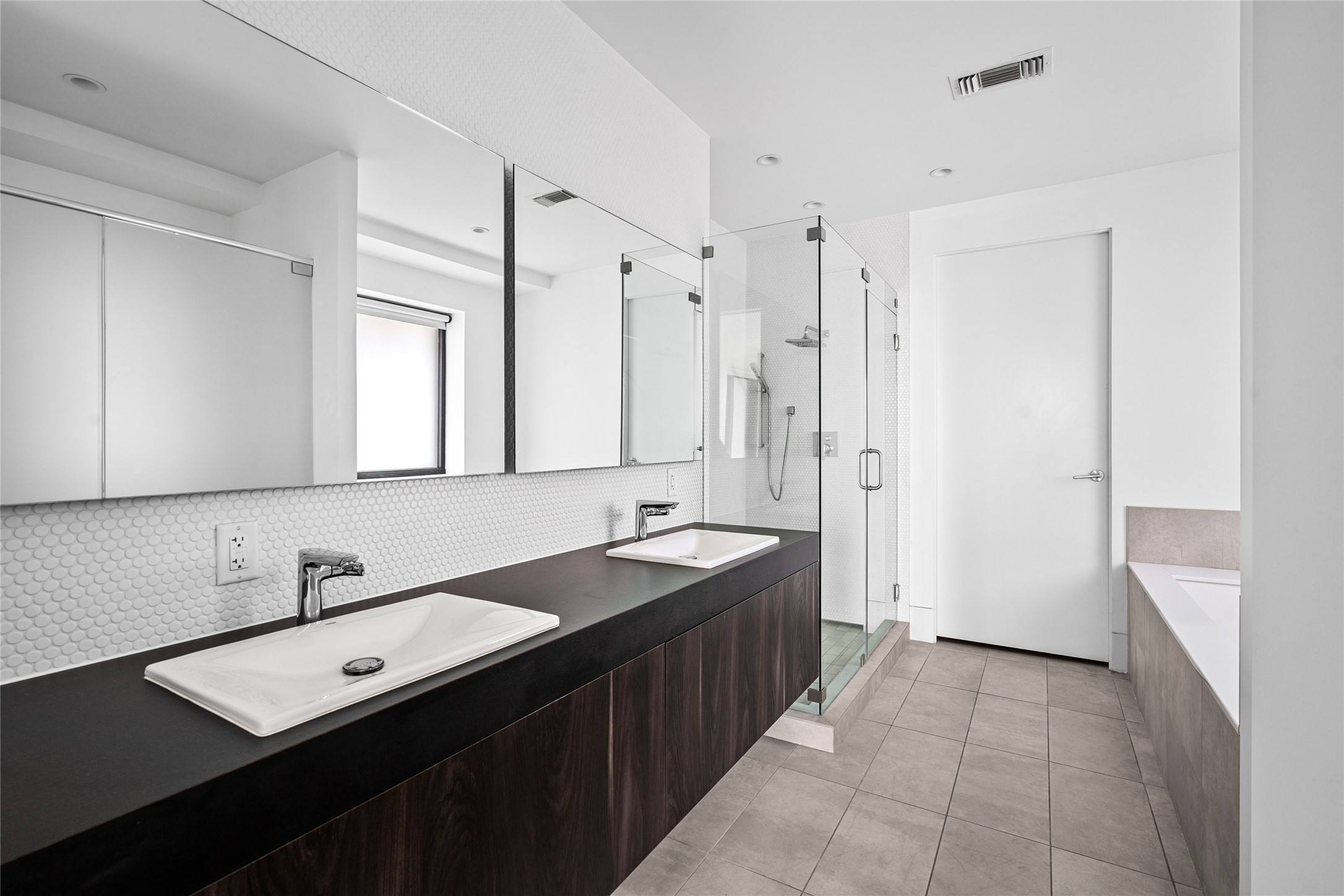 2406 Tangley Street, Unit 200 Houston, TX 77005 - Photo 13 of 20 a spacious bathroom with a double vanity sink a mirror and a shower