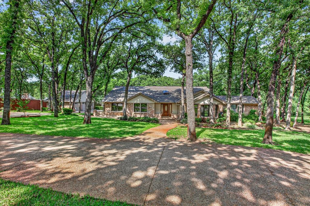 1607 North Main Street Euless, TX 76039 - Photo 1 of 39 a view of house in front of a big yard with large trees