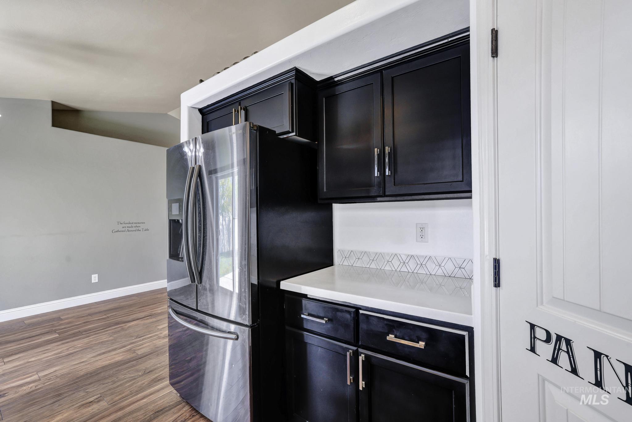 446 Noble Street Twin Falls, ID 83301 - Photo 9 of 42 Kitchenette area featuring dark cabinetry, a light-colored countertop, and a decorative tile backsplash