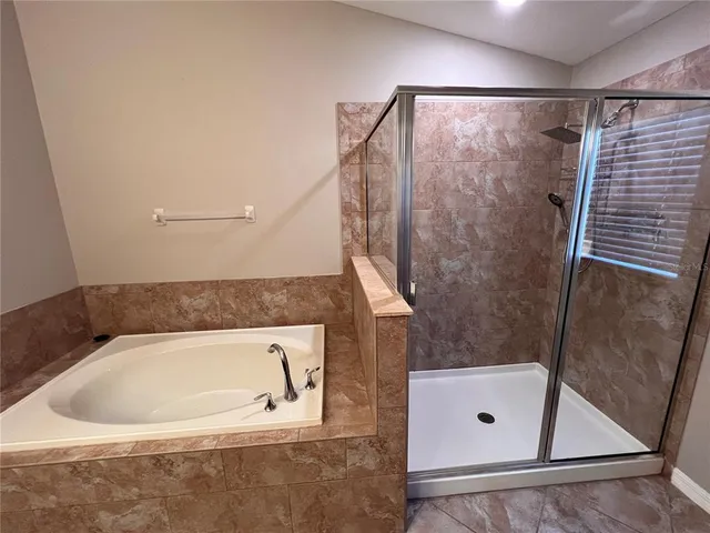 a bathroom with a tub and shower