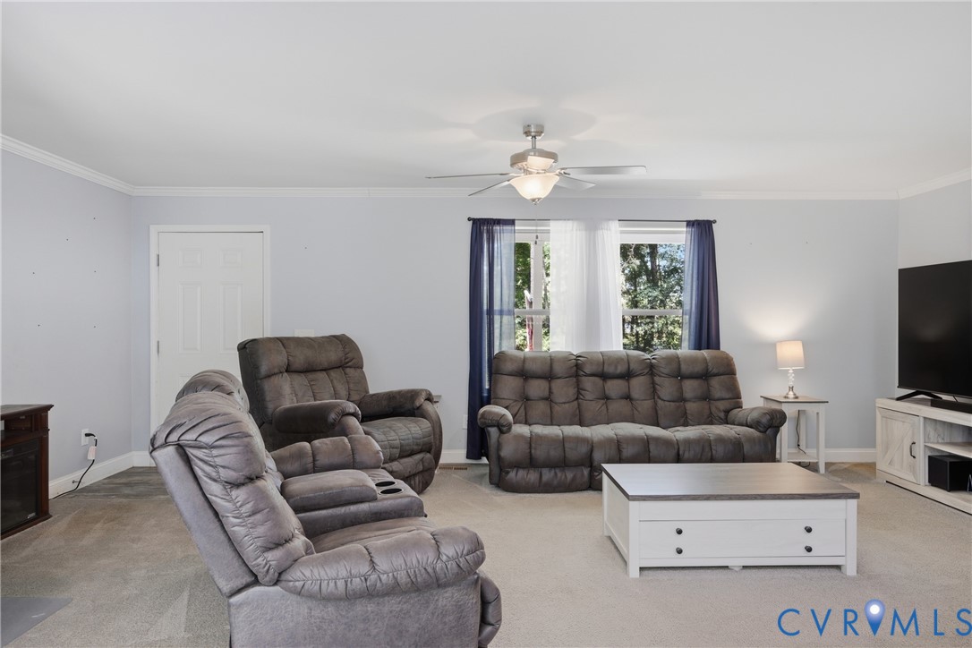 93 Faraway Road Saluda, VA 23149 - Photo 11 of 58 a living room with furniture a flat screen tv and a window