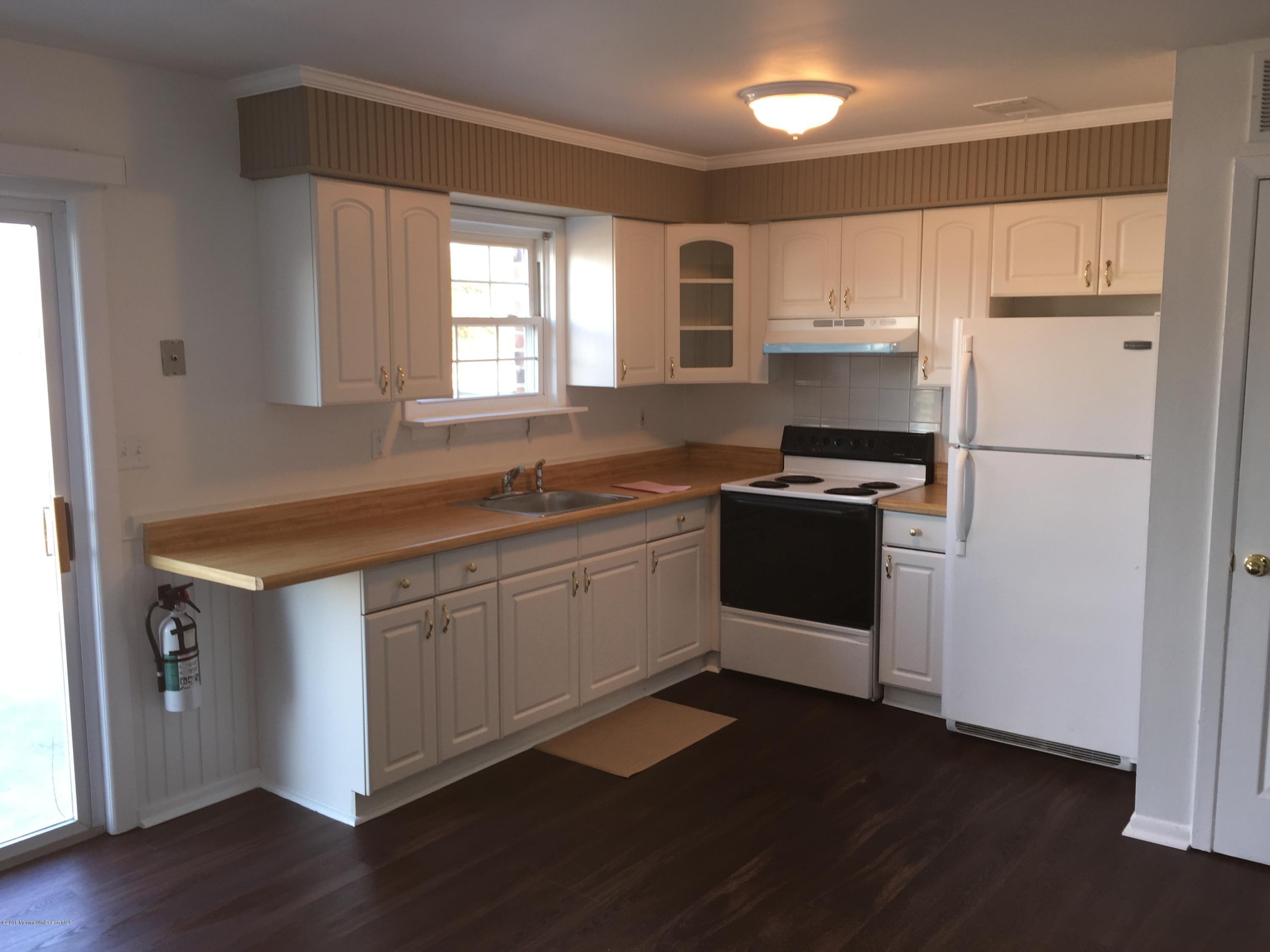 313 Sawmill Road, Unit 58 Brick, NJ 08724 - Photo 1 of 9 a kitchen with a sink a refrigerator and window