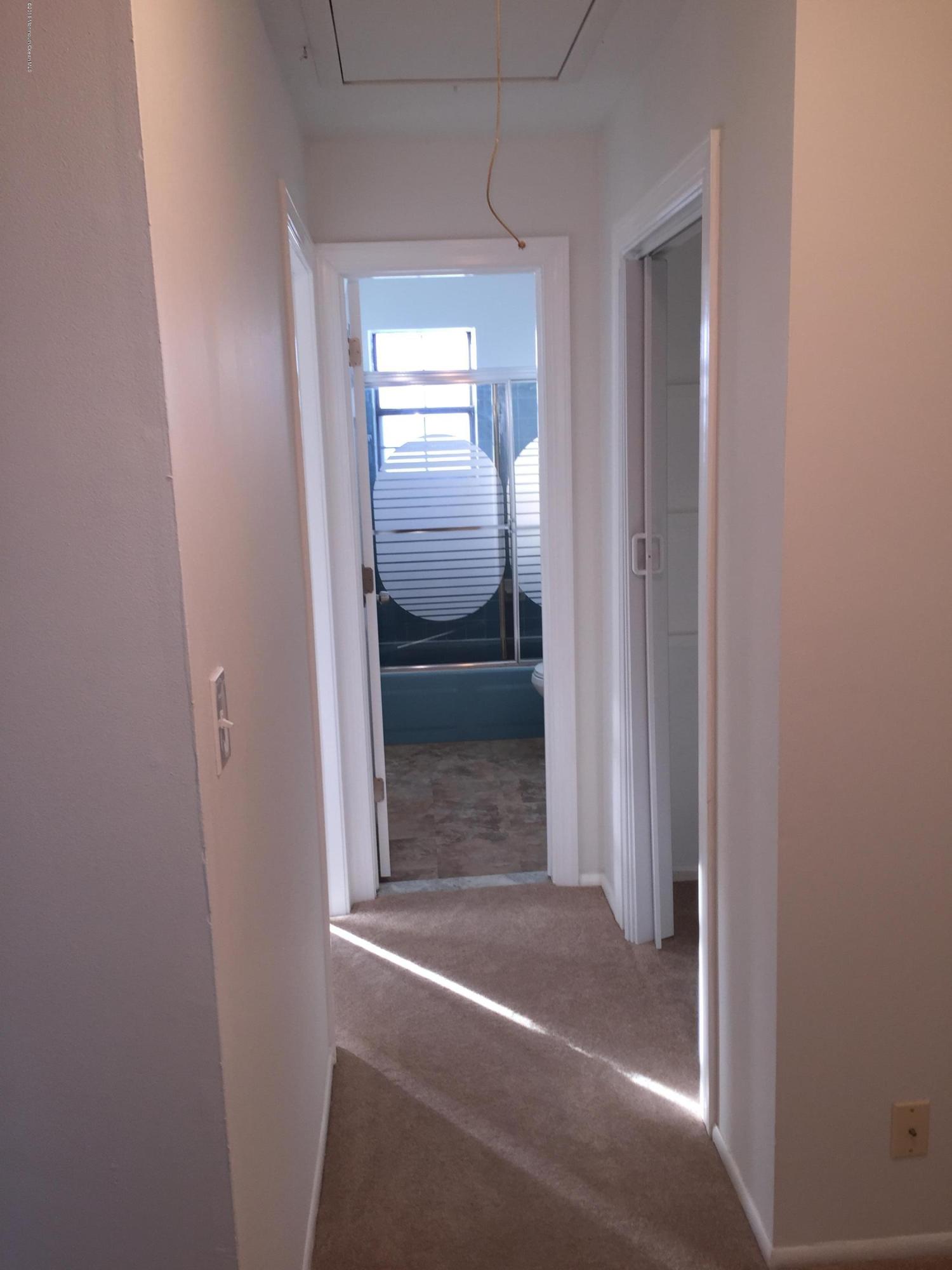313 Sawmill Road, Unit 58 Brick, NJ 08724 - Photo 6 of 9 a view of a closet area with living room