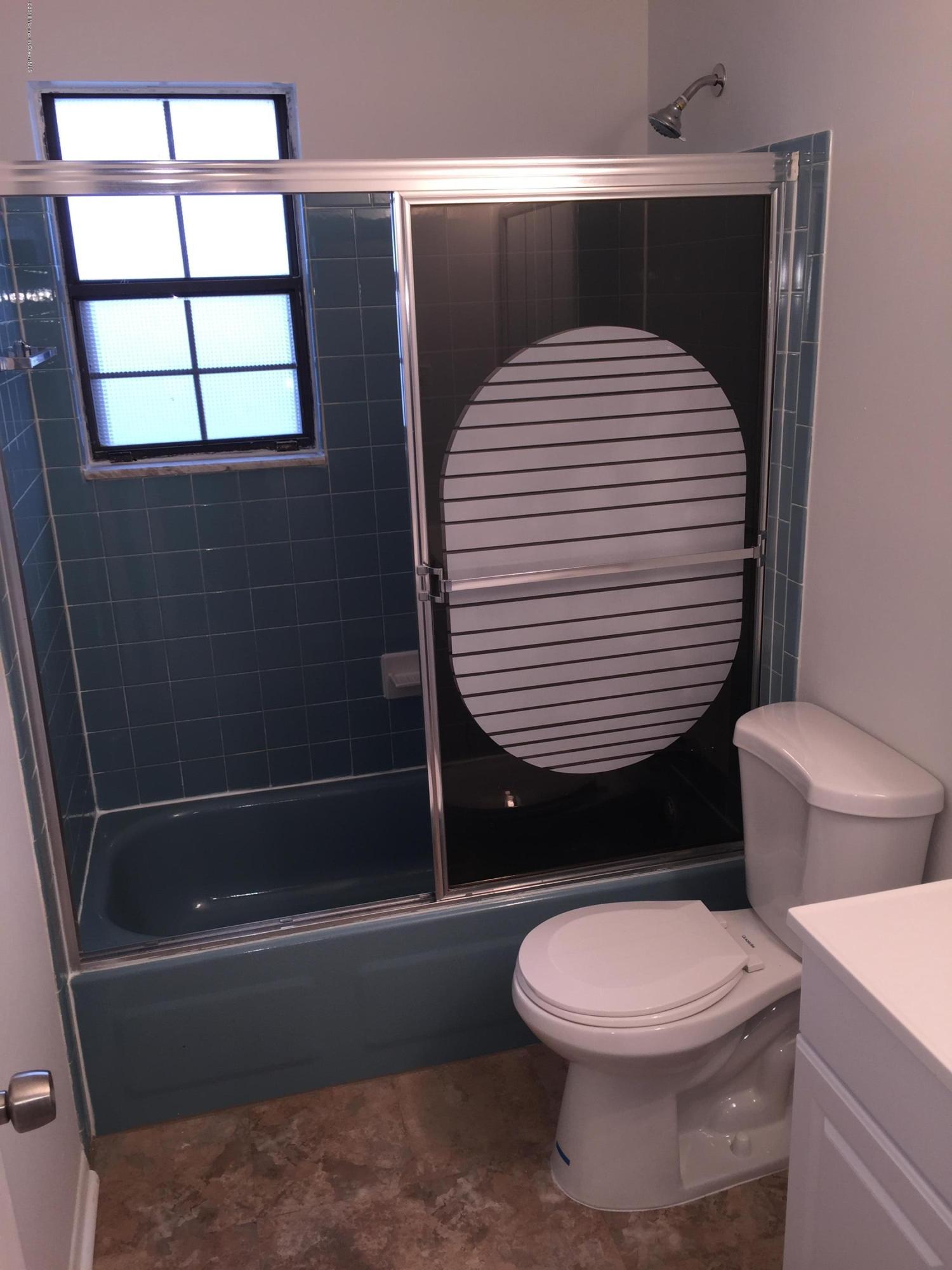 313 Sawmill Road, Unit 58 Brick, NJ 08724 - Photo 8 of 9 a bathroom with a toilet and a shower