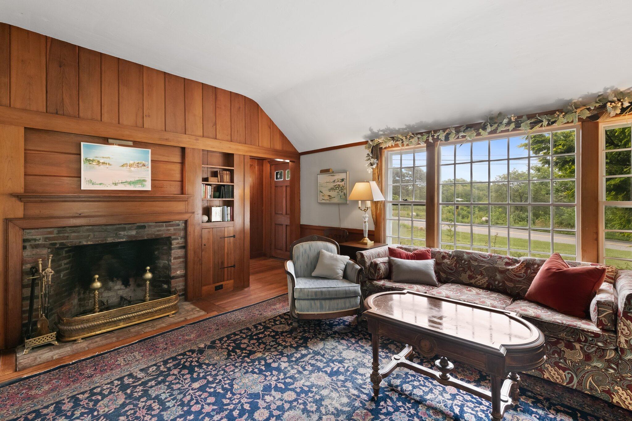 152 Monument Road Orleans, MA 02653 - Photo 11 of 40 a living room with furniture a window and a fireplace