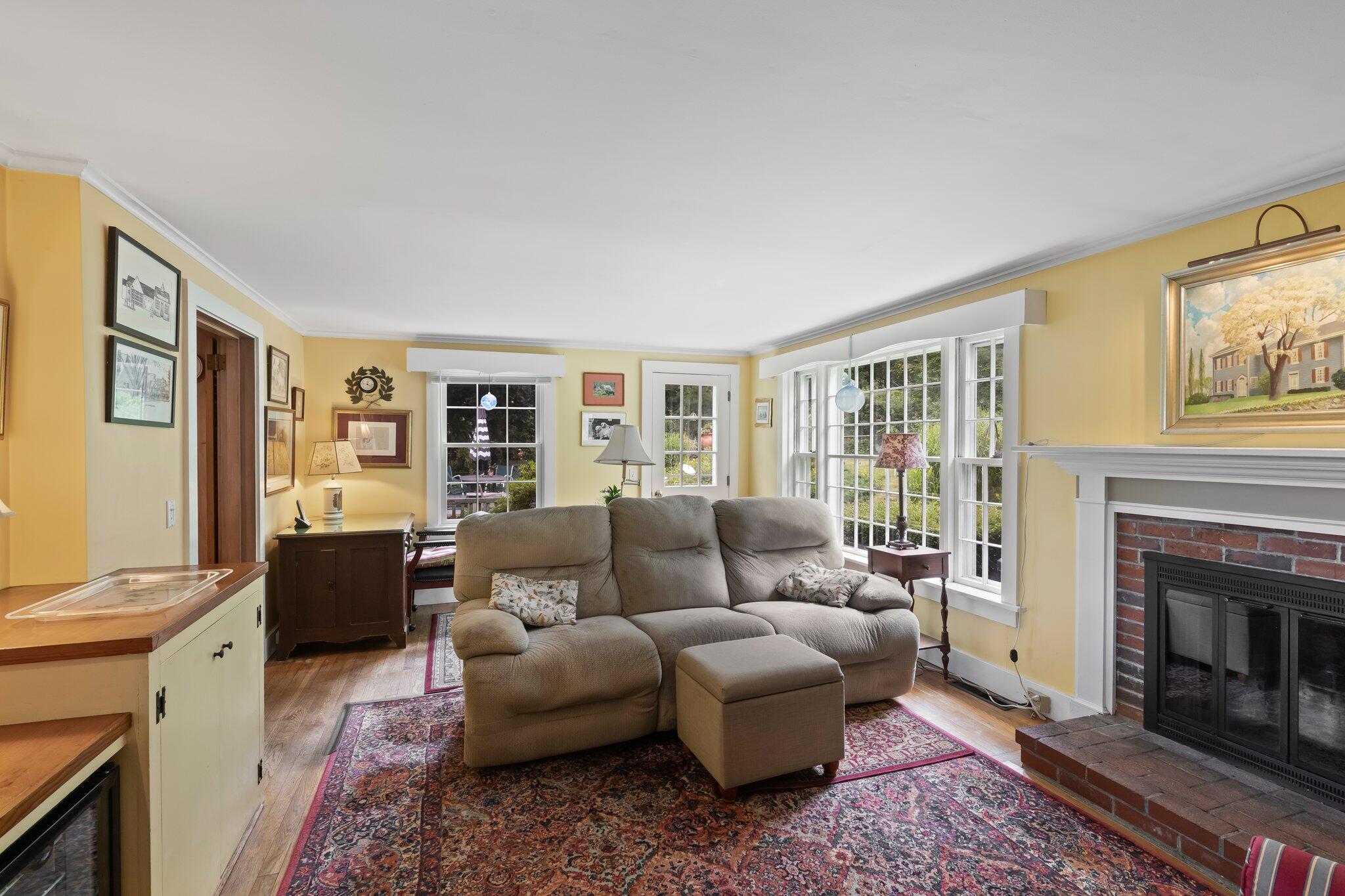 152 Monument Road Orleans, MA 02653 - Photo 20 of 40 a living room with furniture and a fireplace