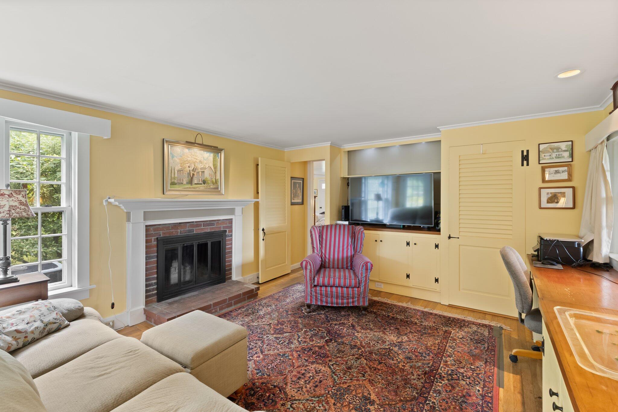 152 Monument Road Orleans, MA 02653 - Photo 21 of 40 a living room with furniture or flat screen tv and a fireplace