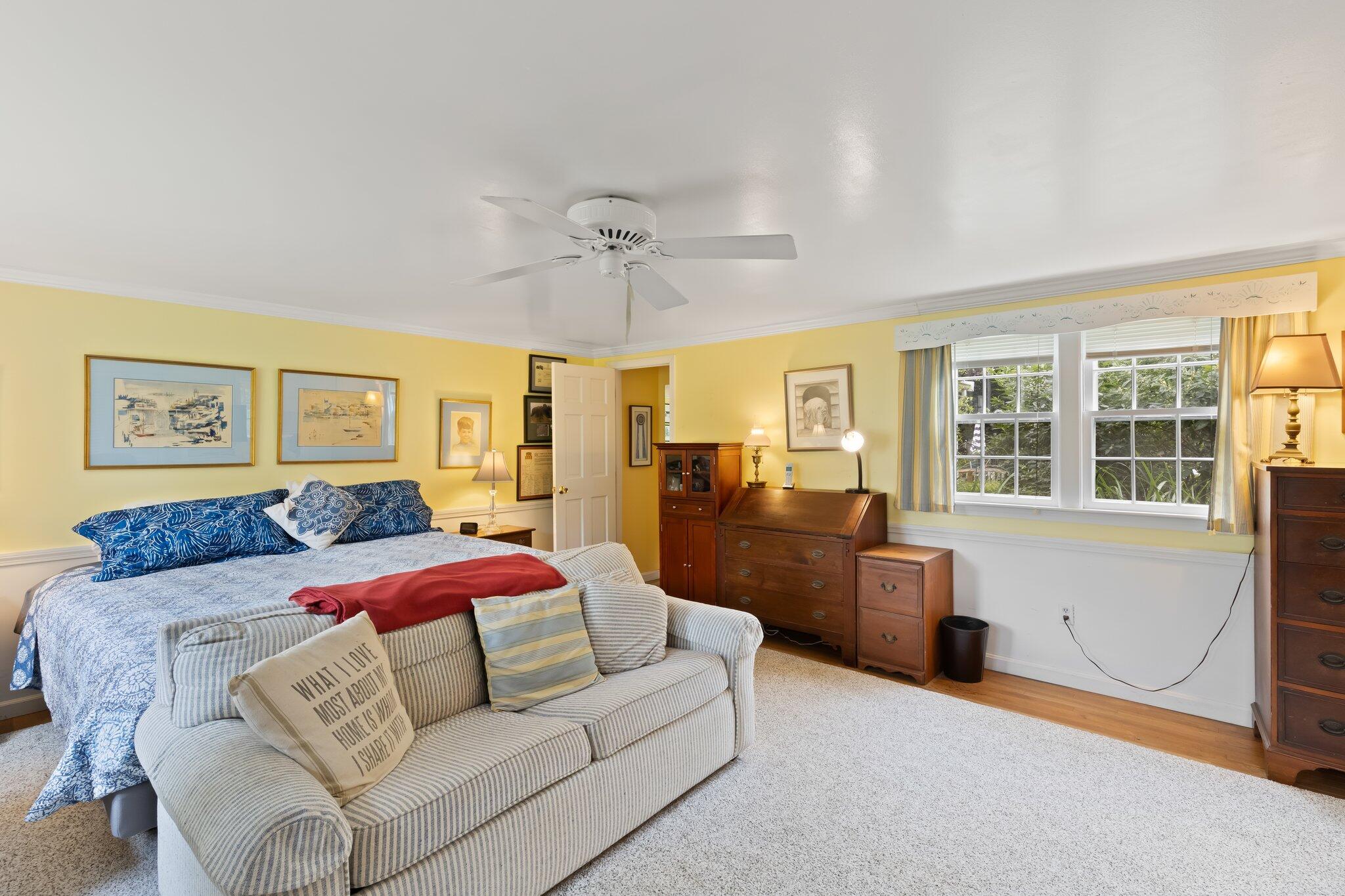152 Monument Road Orleans, MA 02653 - Photo 22 of 40 a bedroom with a large bed couch and windows